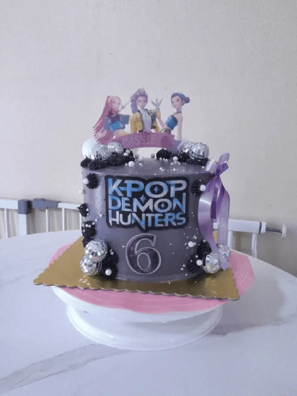 Purple K-pop themed birthday cake with toppers